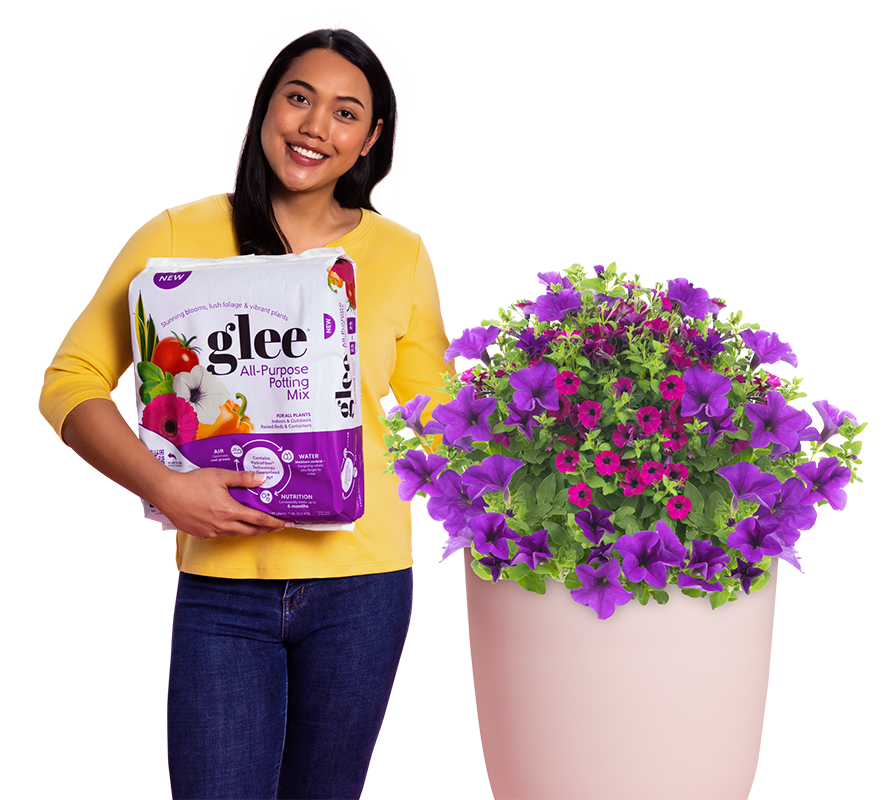 Woman holding a bag of Glee with a large flower planter